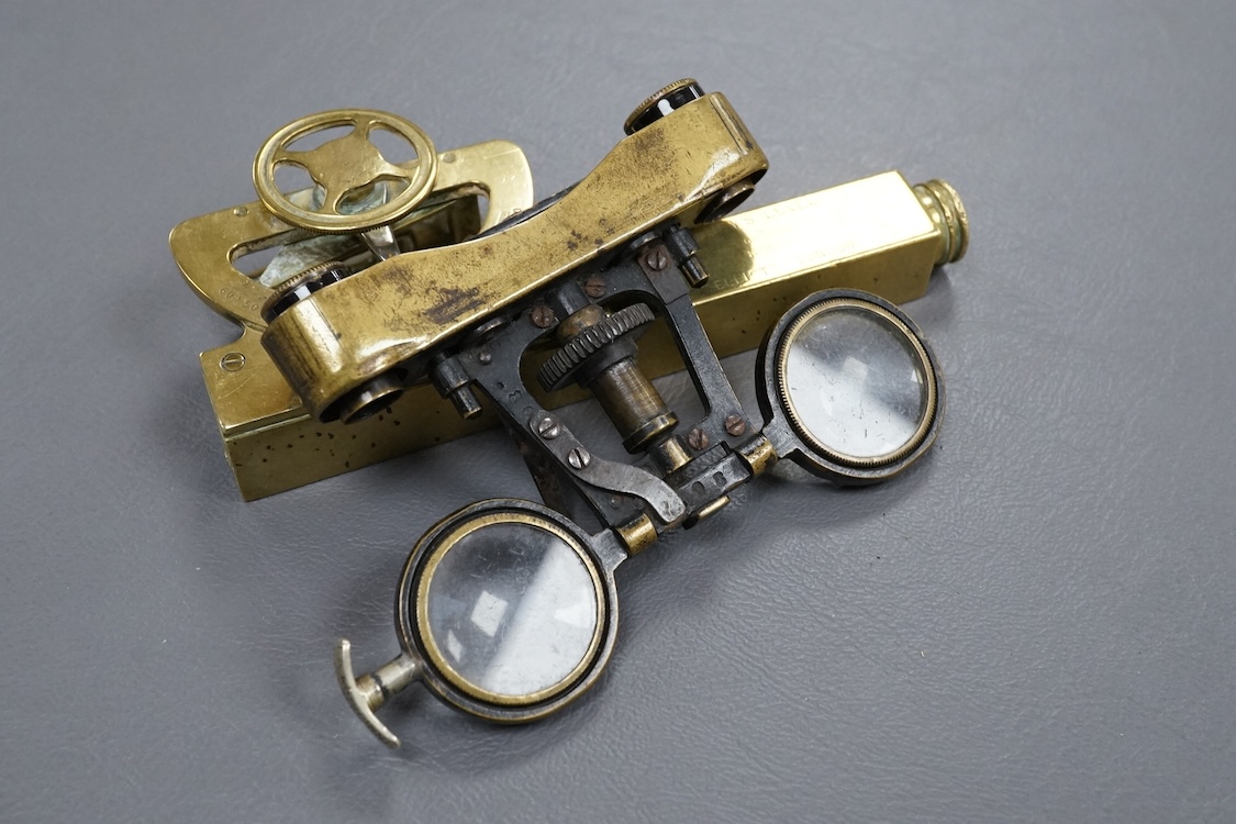 A brass Abney’s level by Elliott, London, 12cm long, together with a pair of folding brass miniature binoculars, 10cm wide.